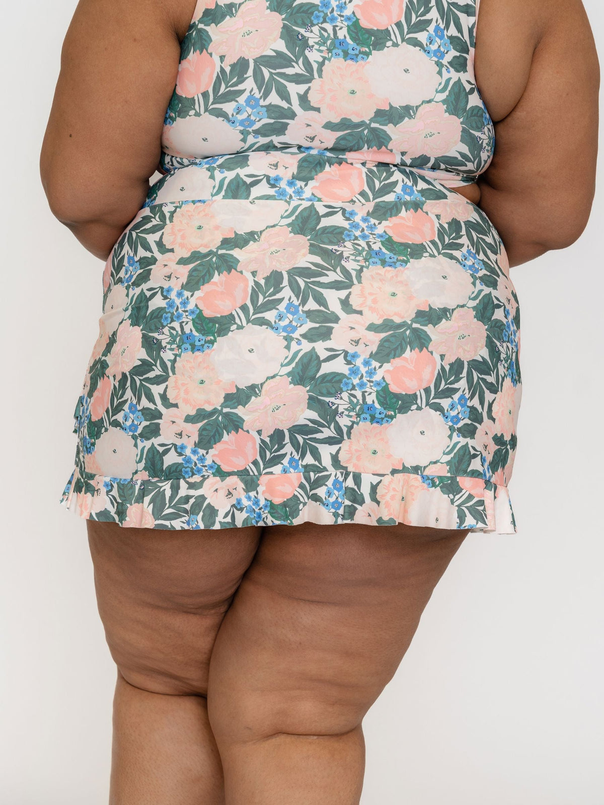 Floral patterned dress worn by a person on a white background