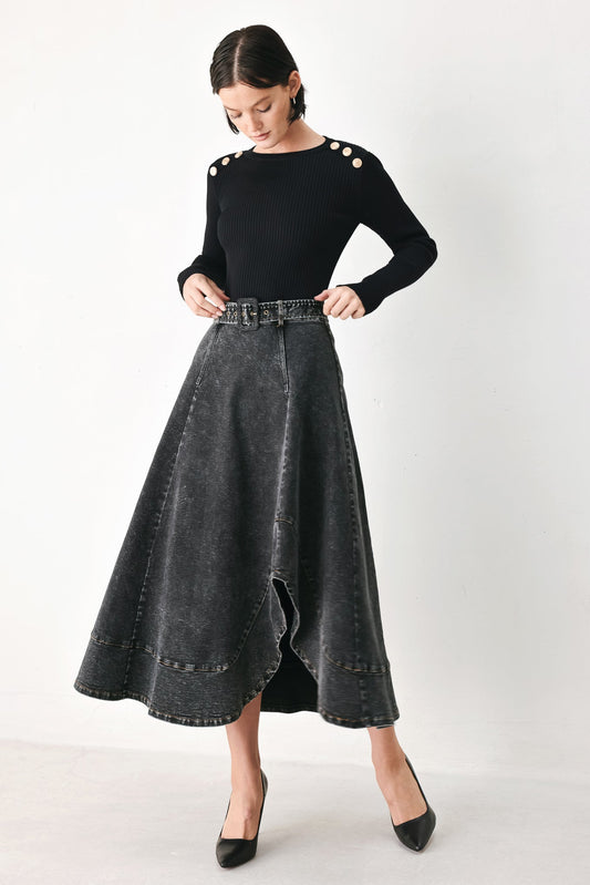 Model wearing a black washed denim midi skirt with an uneven hem and matching denim crop jacket.
