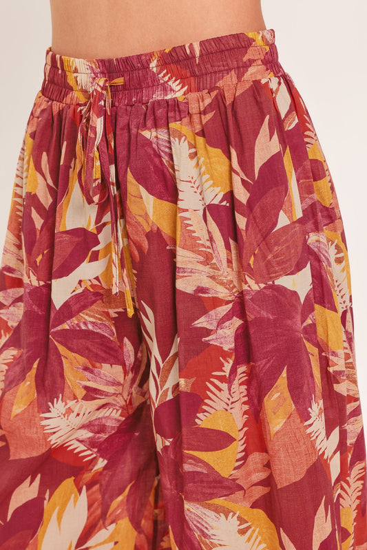 Model wearing burgundy floral palazzo pants with a matching printed cotton top.