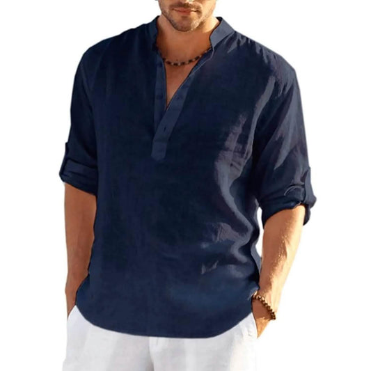Man wearing a navy blue shirt with rolled-up sleeves on a white background