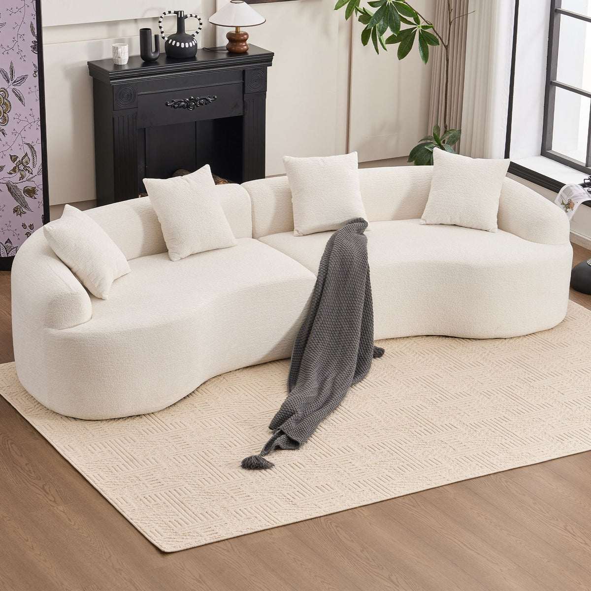 White sofa with white cushions and a gray blanket in a living room setting.