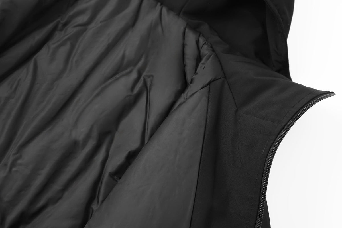 Close-up of a black puffer vest with a focus on texture and design.