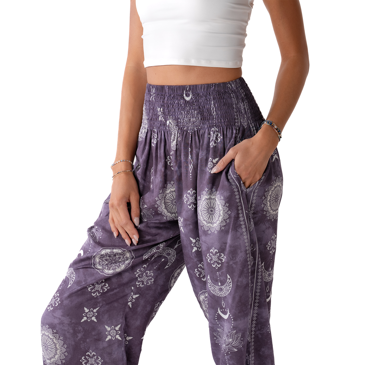 Purple patterned pants worn by a person on a white background