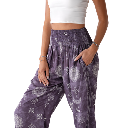 Purple patterned pants worn by a person on a white background