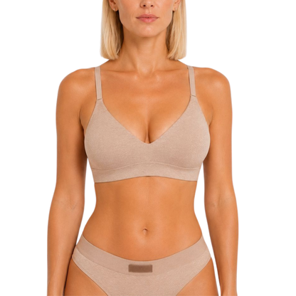 Woman wearing a beige bra and underwear set on a white background