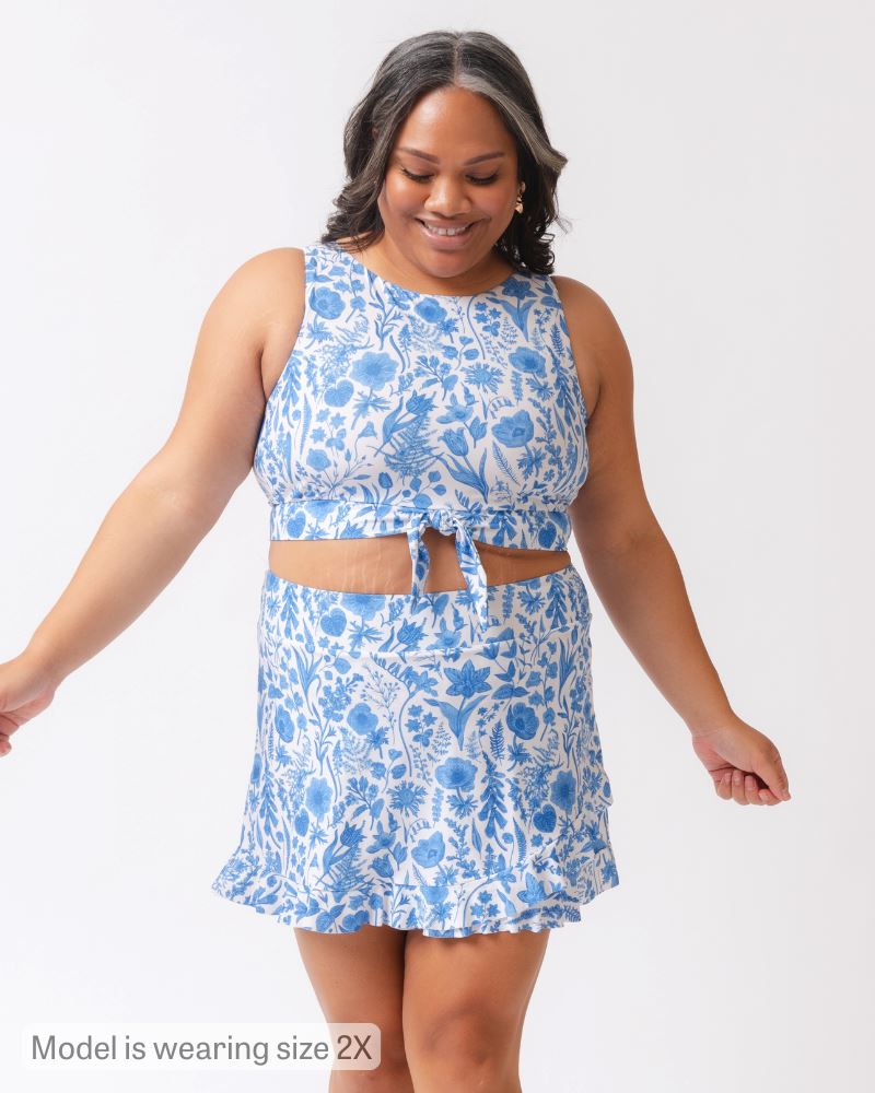 Woman wearing a blue floral dress on a white background