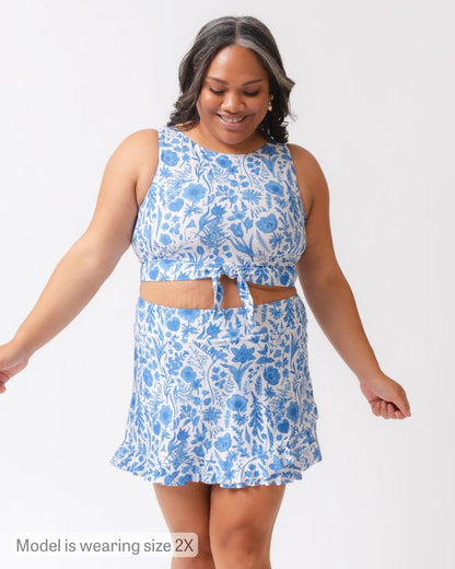 Woman wearing a blue floral dress on a white background