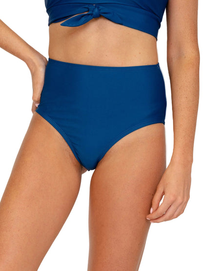 A model wearing a solid royal blue two-piece bikini, featuring high-waisted bottoms and a matching tie-front crop top, shown against a plain white background.