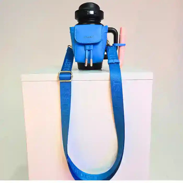 Blue backpack with a water bottle on a white surface