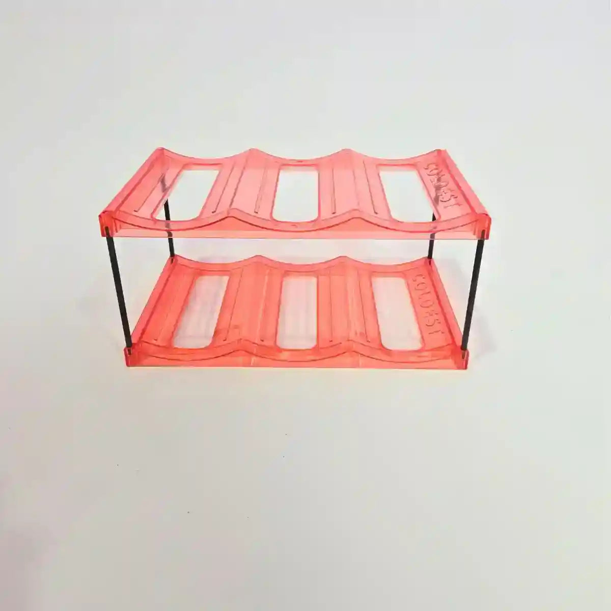A two-tier acrylic shelf with a translucent orange-red finish and black metal support legs, shown against a plain white background.