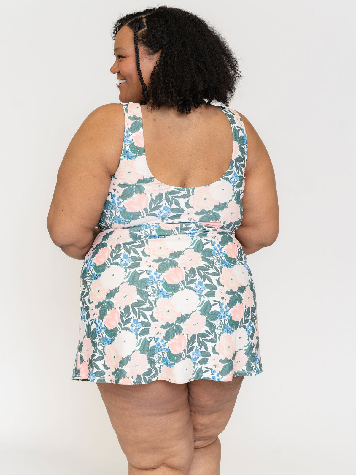 Woman wearing a floral dress against a white background