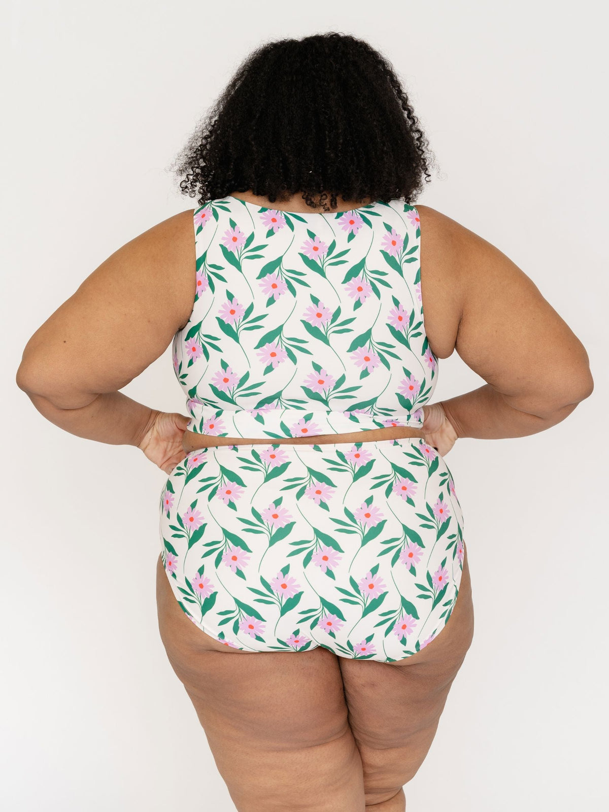Person wearing a floral two-piece set on a white background