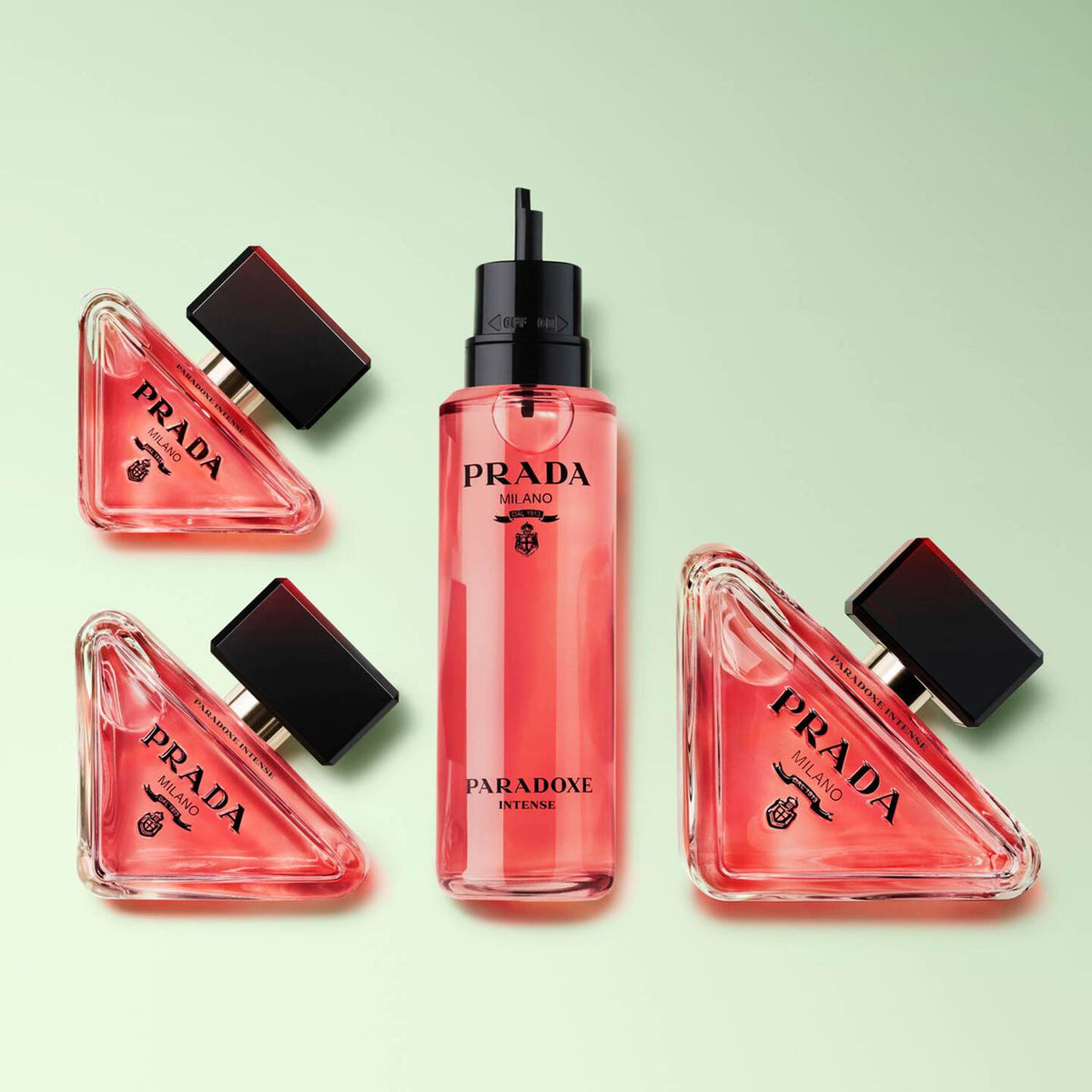 Prada Paradoxe Intense perfume bottles on a light green background