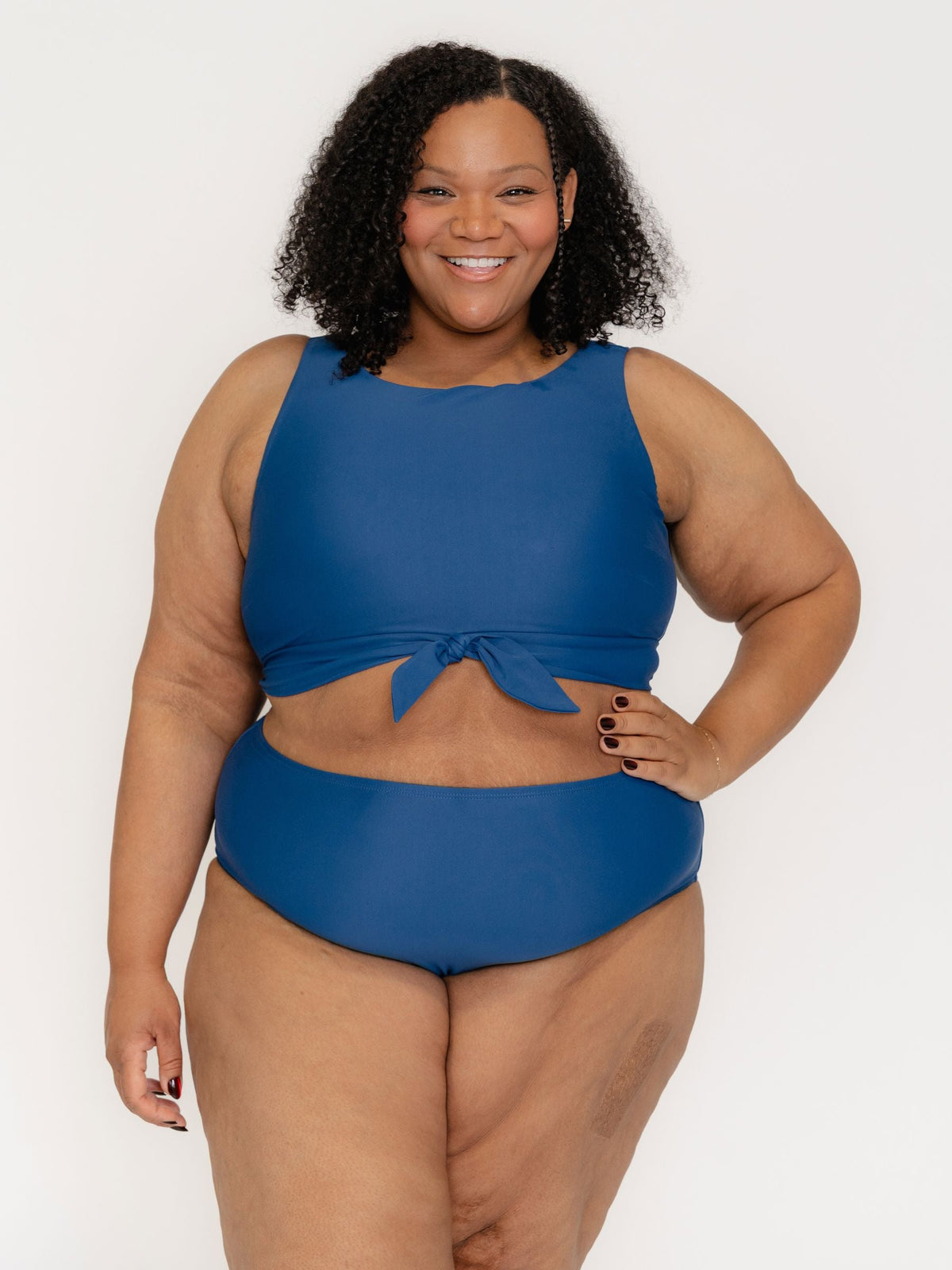 Woman wearing a blue bikini set on a white background