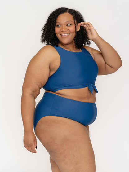 Woman wearing a blue bikini set on a white background