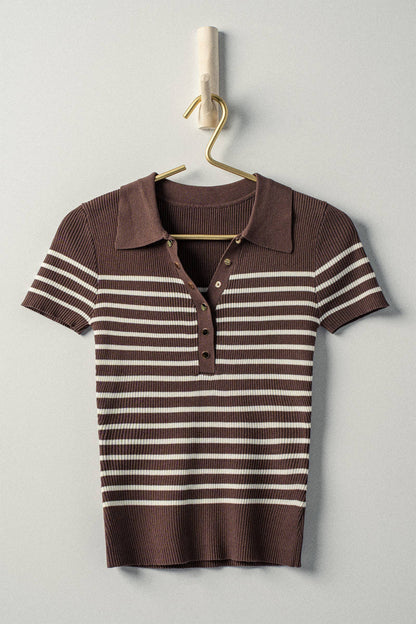 Brown and white striped polo shirt on a hanger against a light gray background