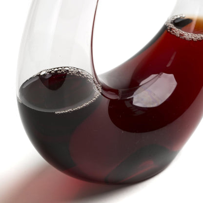 Close-up of a glass filled with red wine on a white background