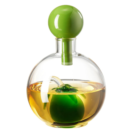 Clear glass bottle with green cap and green apple inside on a white background