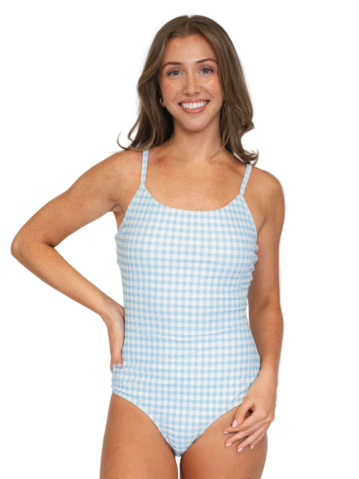 A woman modeling a one-piece swimsuit with a light blue and white gingham check pattern against a solid white background.