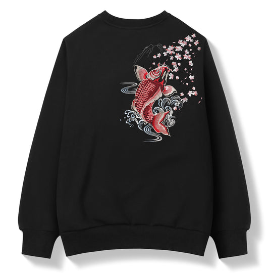 A black crewneck sweatshirt featuring a detailed graphic print of a red and white koi fish, white waves, and pink cherry blossoms on the front, displayed against a clean white background.