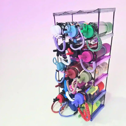 Colorful dog toys on a tiered display stand against a light purple background