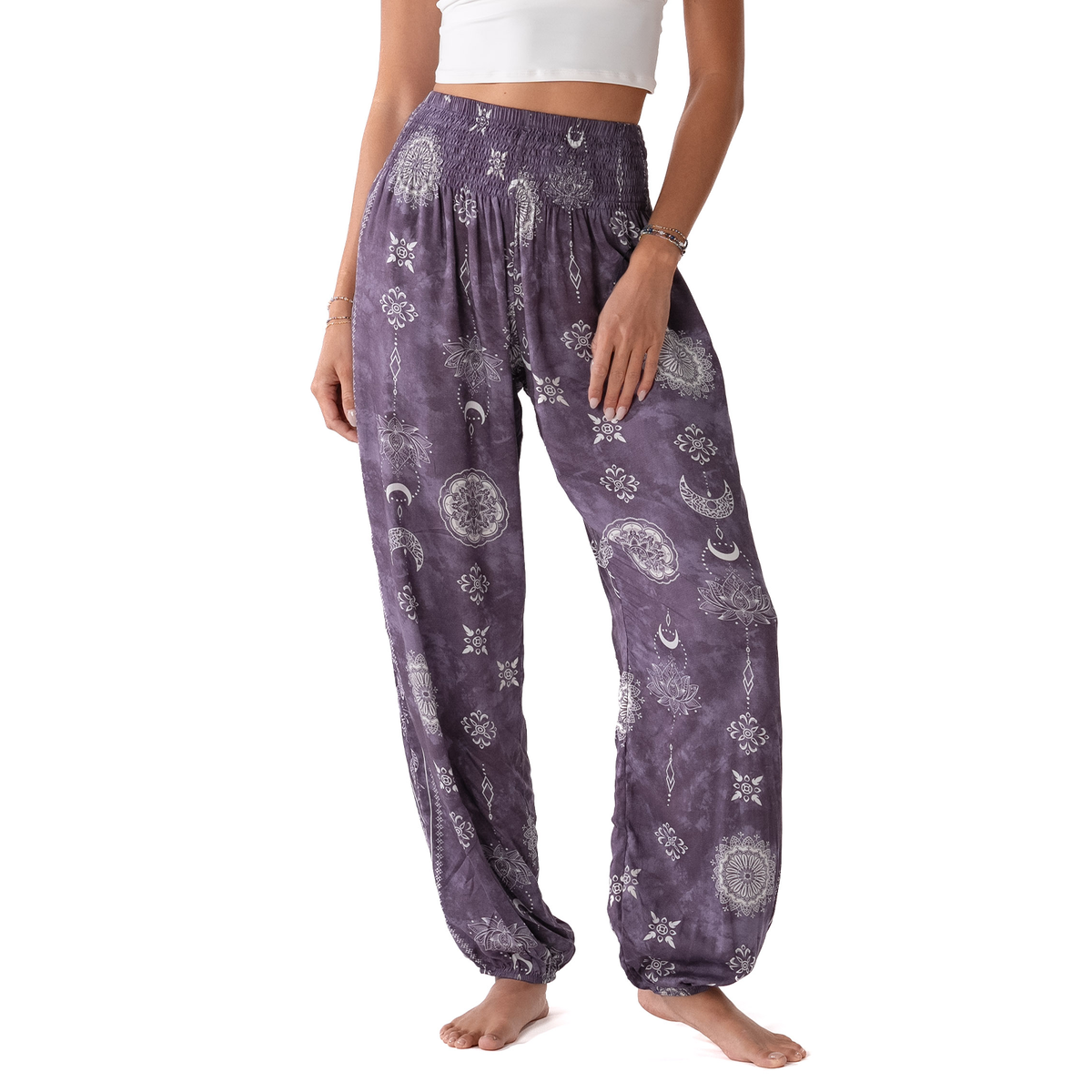 Purple harem-style pants with a white celestial print, modeled on a person against a white background.