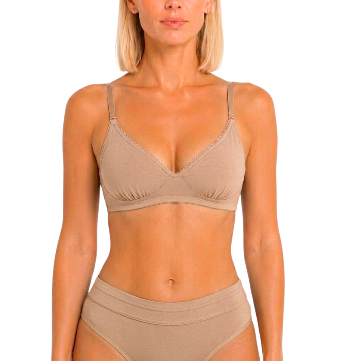 A woman modeling a beige bralette and matching high-waisted briefs against a plain white background.