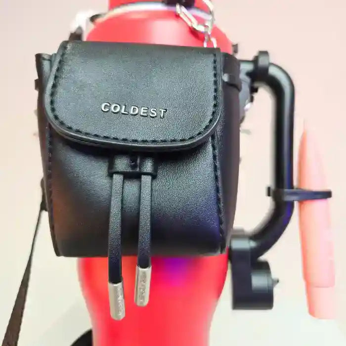 Black leather pouch with 'COLDEST' branding attached to a red object.
