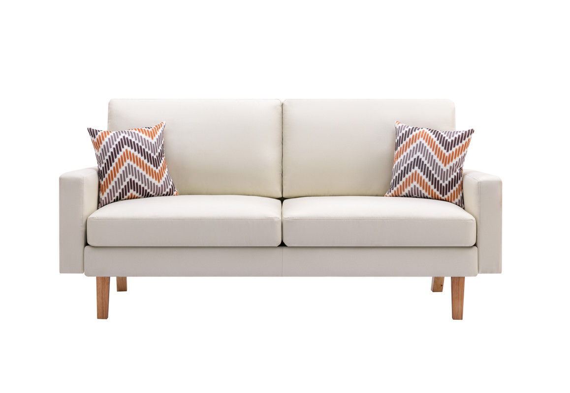 Bahamas sofa with throw pillows against a plain wall
