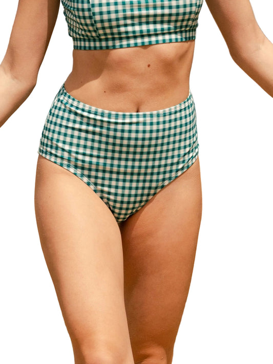 A model wearing a green and white gingham bikini set, featuring a cropped top and high-waisted bottoms, shown against a plain white background.