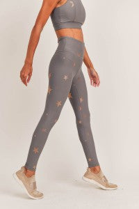 Person wearing gray leggings with a subtle pattern on a white background
