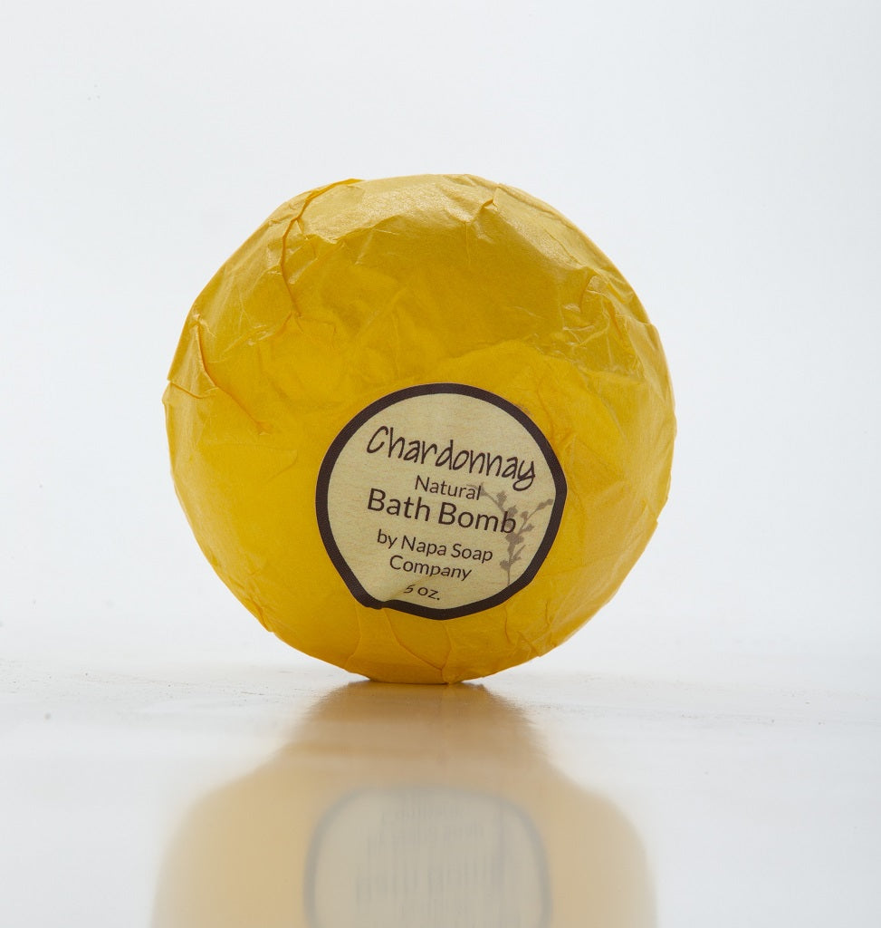 Yellow bath bomb with a label on a white background