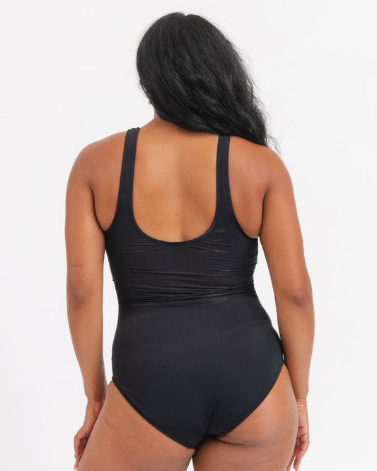 Person wearing a black swimsuit on a white background