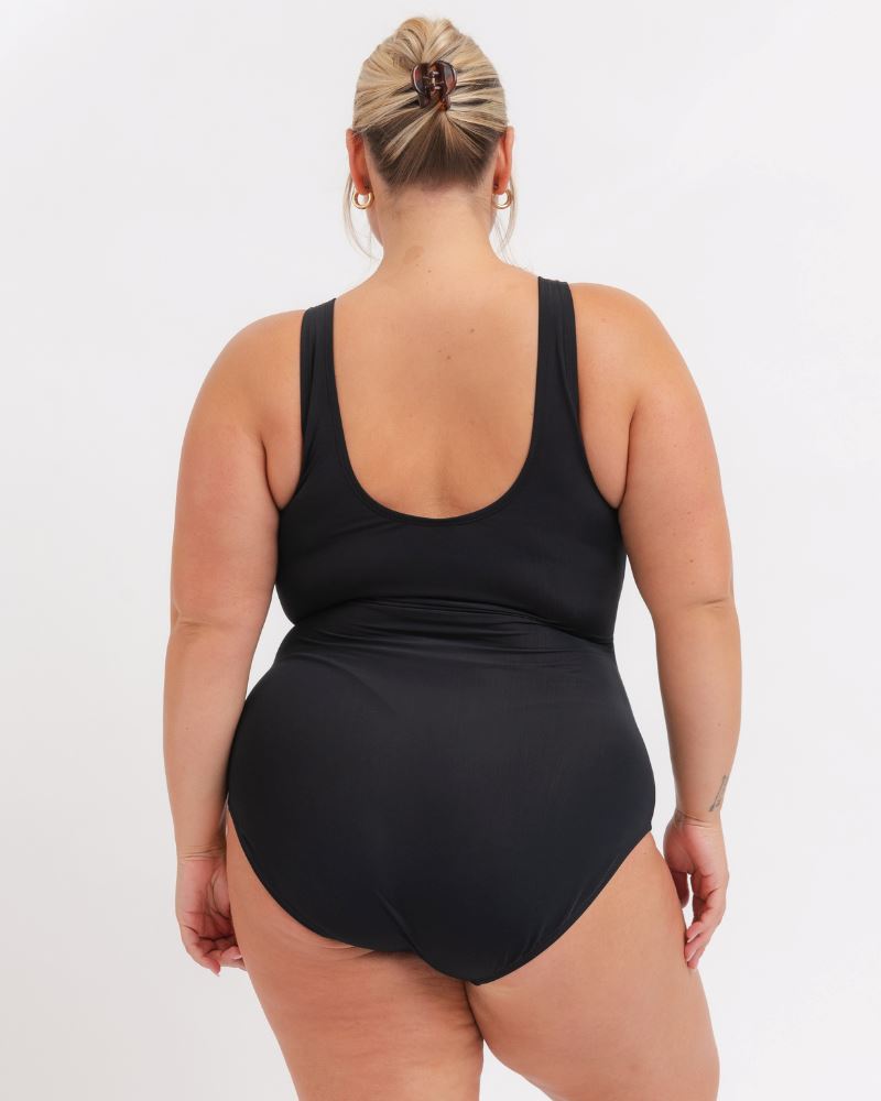 Person wearing a black swimsuit on a white background