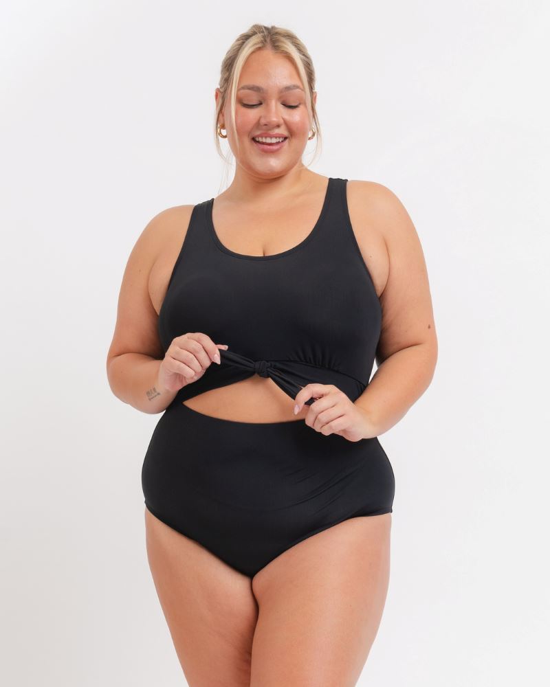 Woman wearing a black swimsuit on a white background