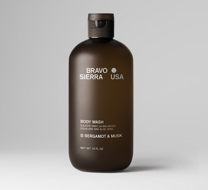 A 13 fl oz bottle of Oris & Santal Body Wash by Bravo Sierra, featuring a dark brown translucent bottle and a black cap, set against a clean white background.