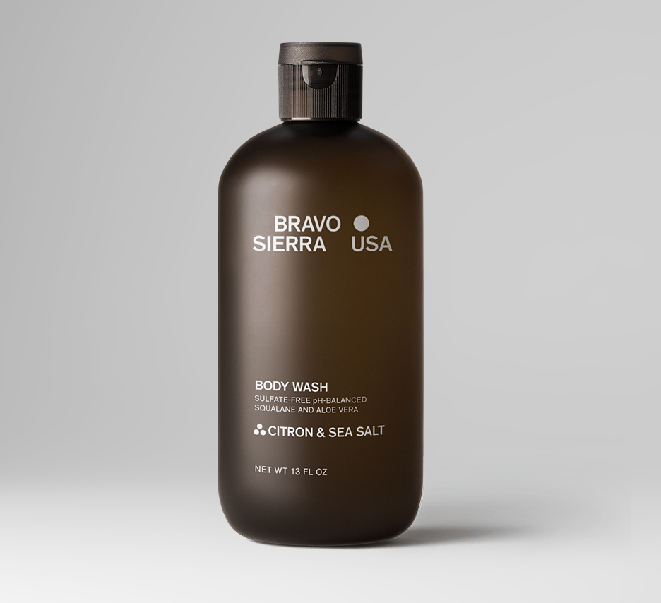 A 13 fl oz bottle of Oris & Santal Body Wash by Bravo Sierra, featuring a dark brown translucent bottle and a black cap, set against a clean white background.