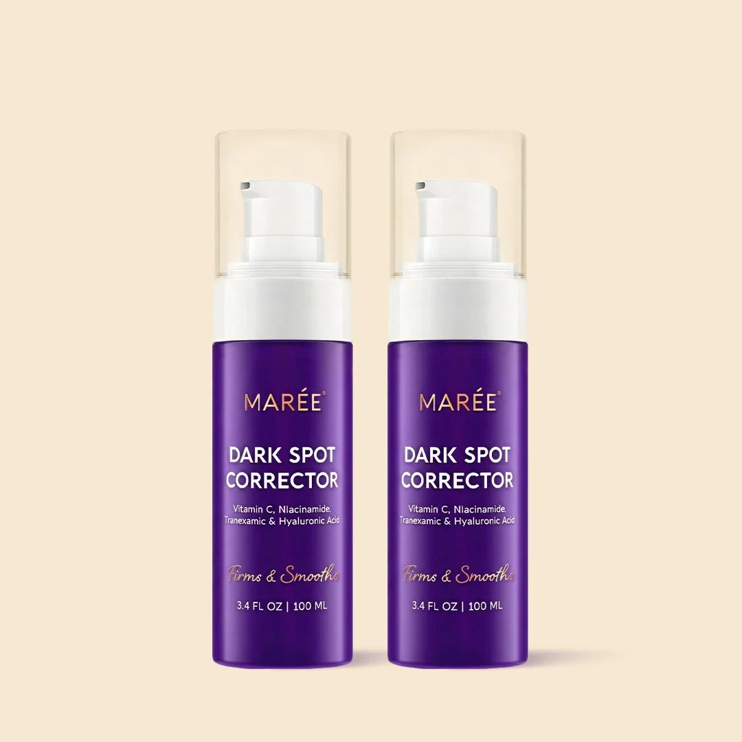 Two purple MARÉE Dark Spot Corrector pump bottles with clear caps, shown side by side on a light beige background.
