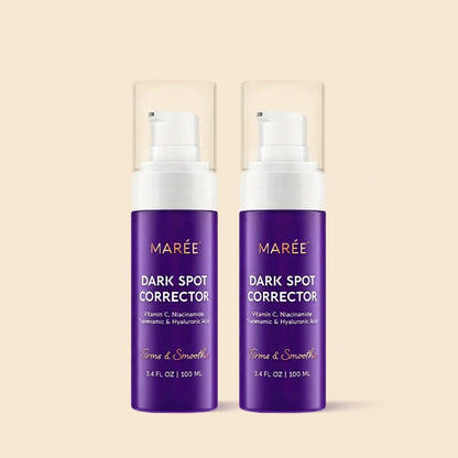 Two purple MARÉE Dark Spot Corrector pump bottles with clear caps, shown side by side on a light beige background.