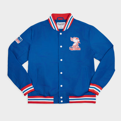 A blue Mitchell & Ness varsity jacket with red and white striped ribbed collar, cuffs, and hem, featuring a red and white buffalo graphic on the left chest and a Mitchell & Ness brand patch on the right sleeve.