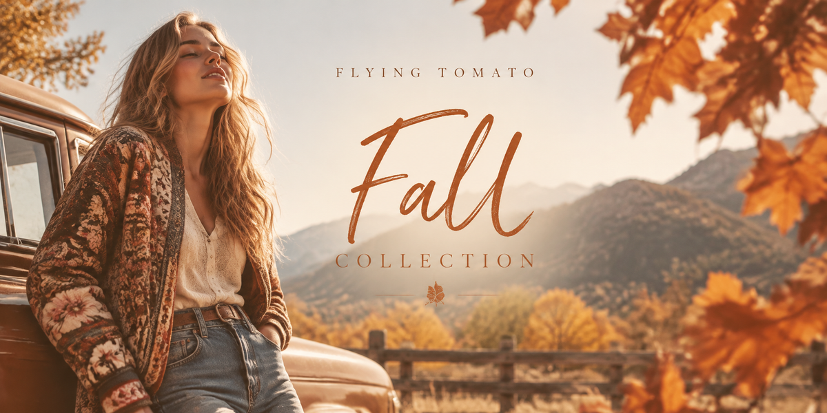 A woman leans against a vintage car outdoors in a warm autumn setting, wearing a patterned brown cardigan, white top, and blue jeans. Large text reads 'FLYING TOMATO Fall COLLECTION' with mountains and orange leaves in the background.