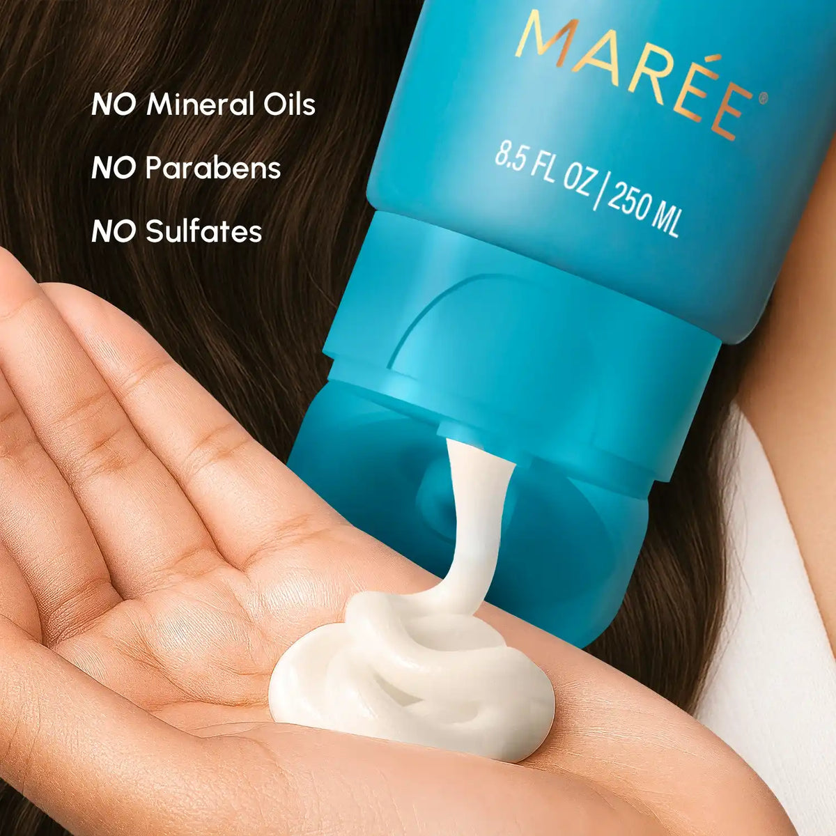 Blue container of skincare product being dispensed onto a hand with 'Maree' branding.