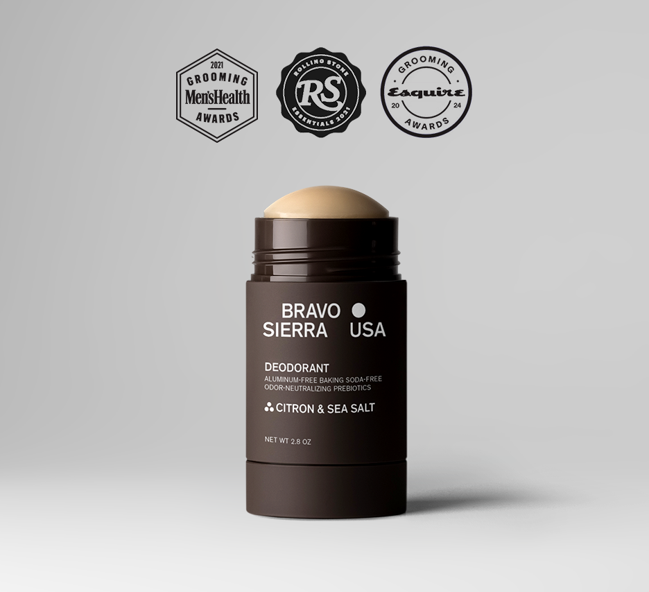 A brown deodorant stick labeled BRAVO SIERRA USA by ORRIS & SANTAL, shown on a light gray background with three award badges above it.