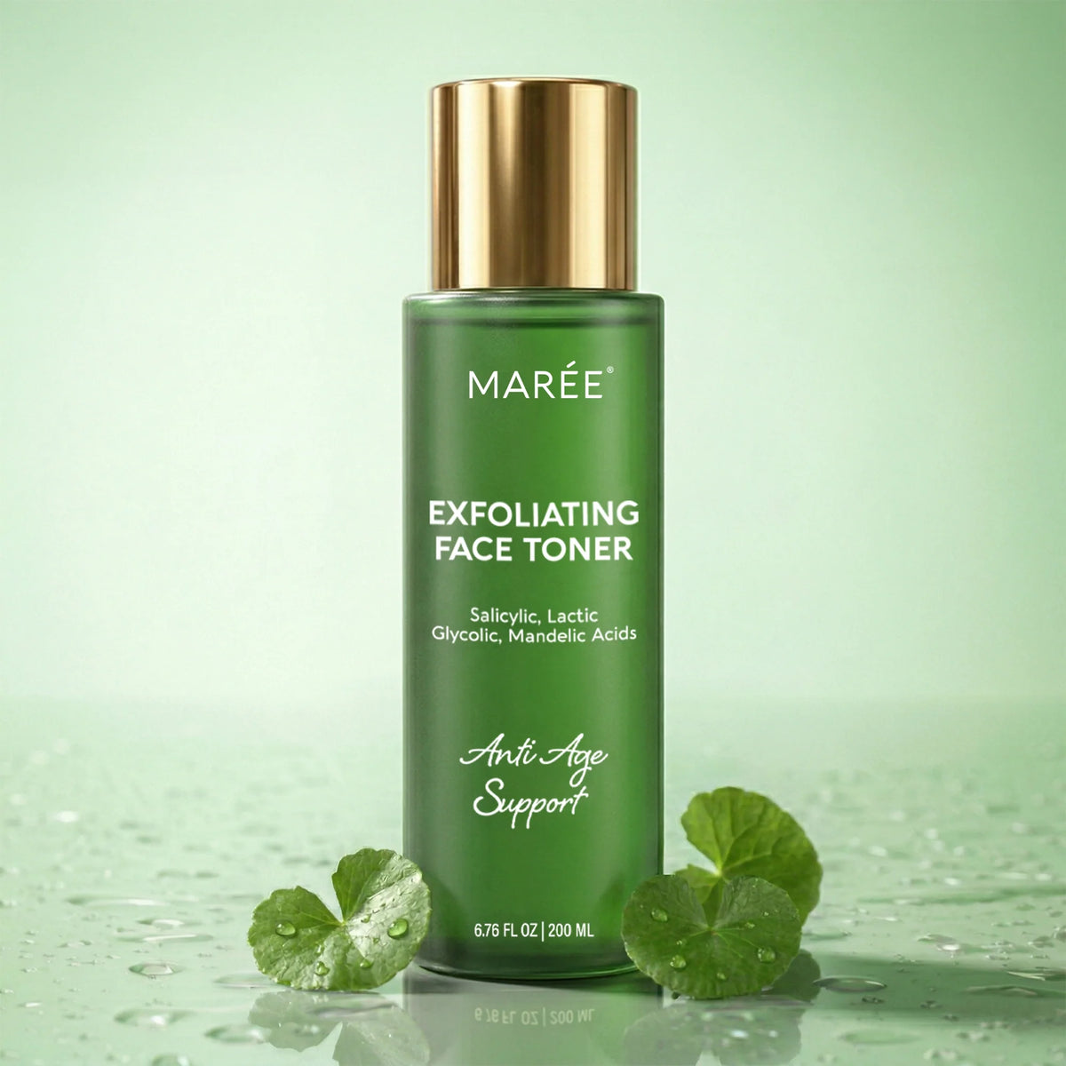 A green bottle of MARÉE Exfoliating Face Toner with a metallic gold cap, set against a soft mint green background with water droplets and green leaves at the base.