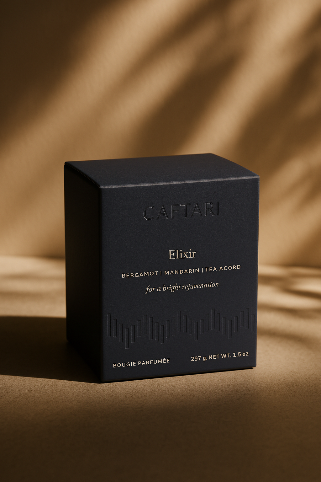 Black Caftari Elixir candle gift box on a brown background