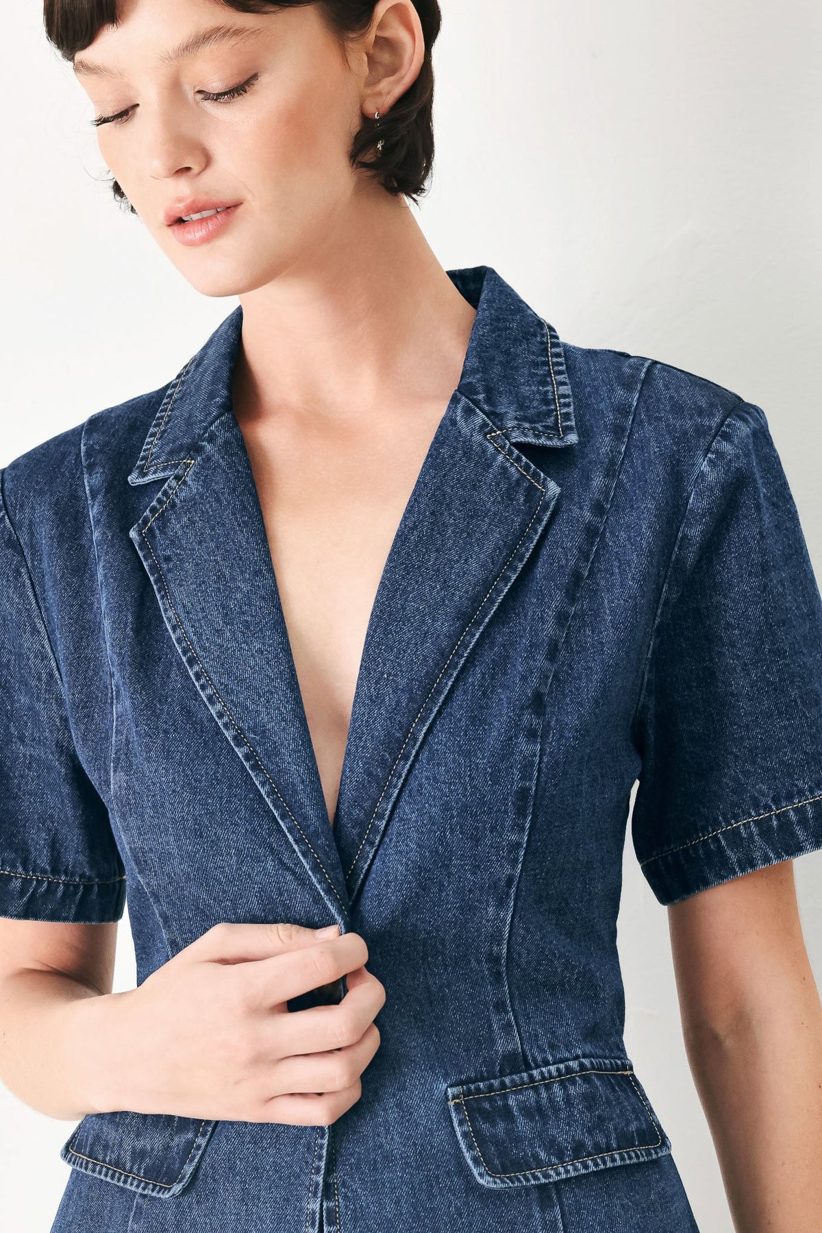 Short-sleeve denim jacket with a collared neckline and deep V-front.