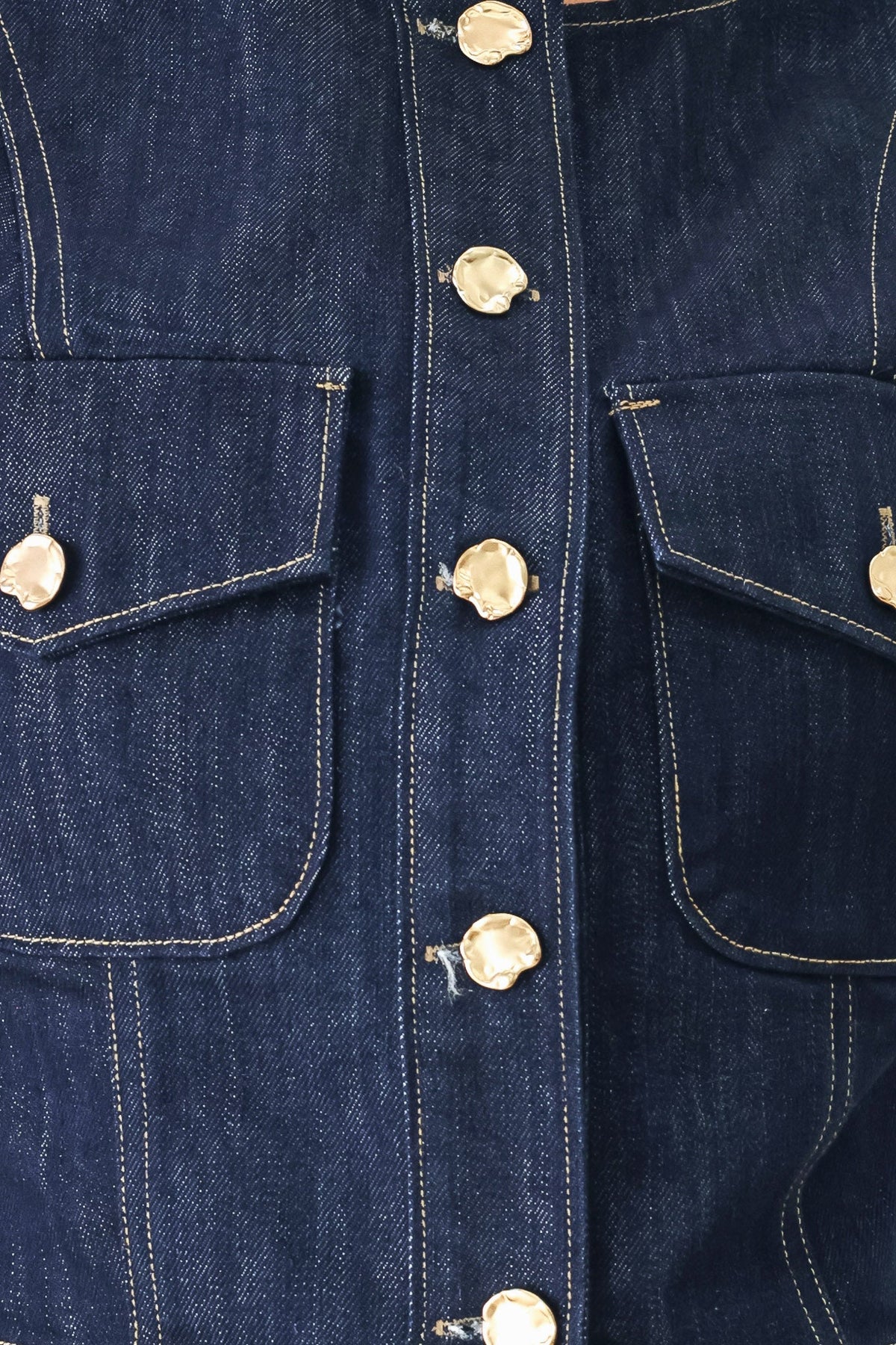 Close-up of the indigo cotton-blend denim fabric used for the Iconic Indigo crop vest.