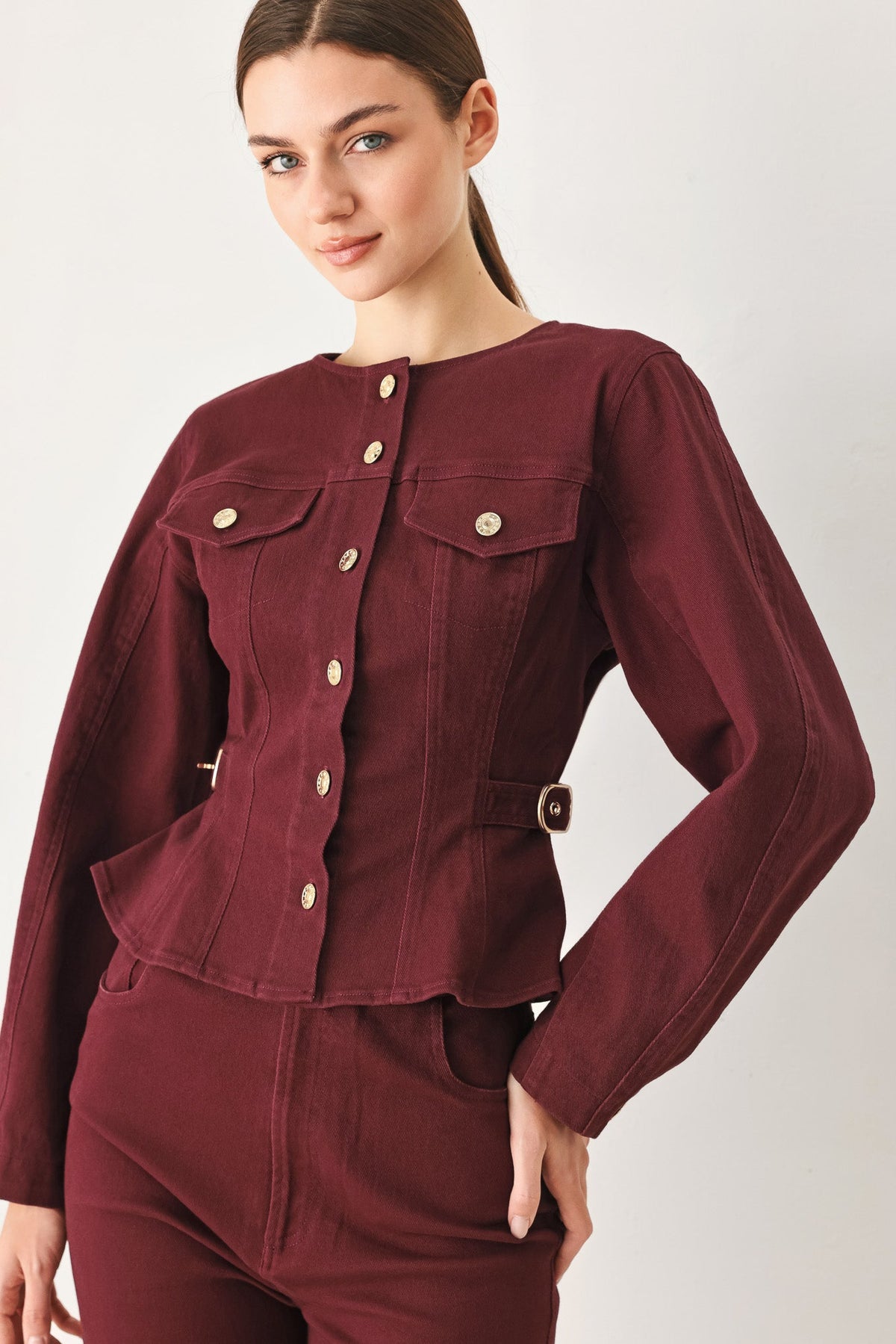 Burgundy long-sleeve woven jacket worn on a model in a light studio setting.
