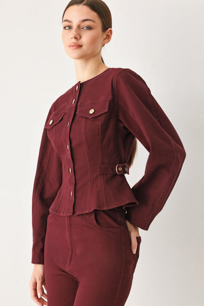 Close-up of the button placket on the burgundy woven jacket.