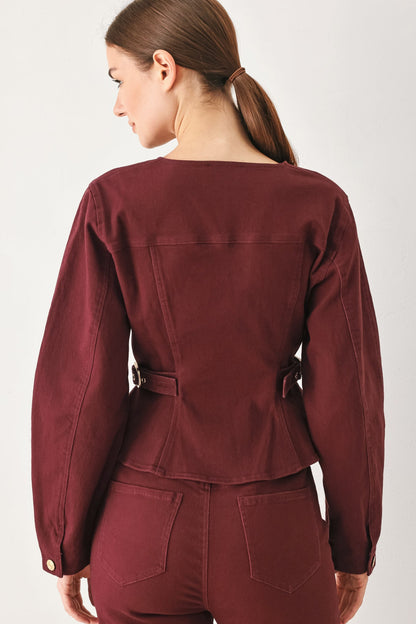 Back view of the burgundy woven jacket on a model against a plain background.